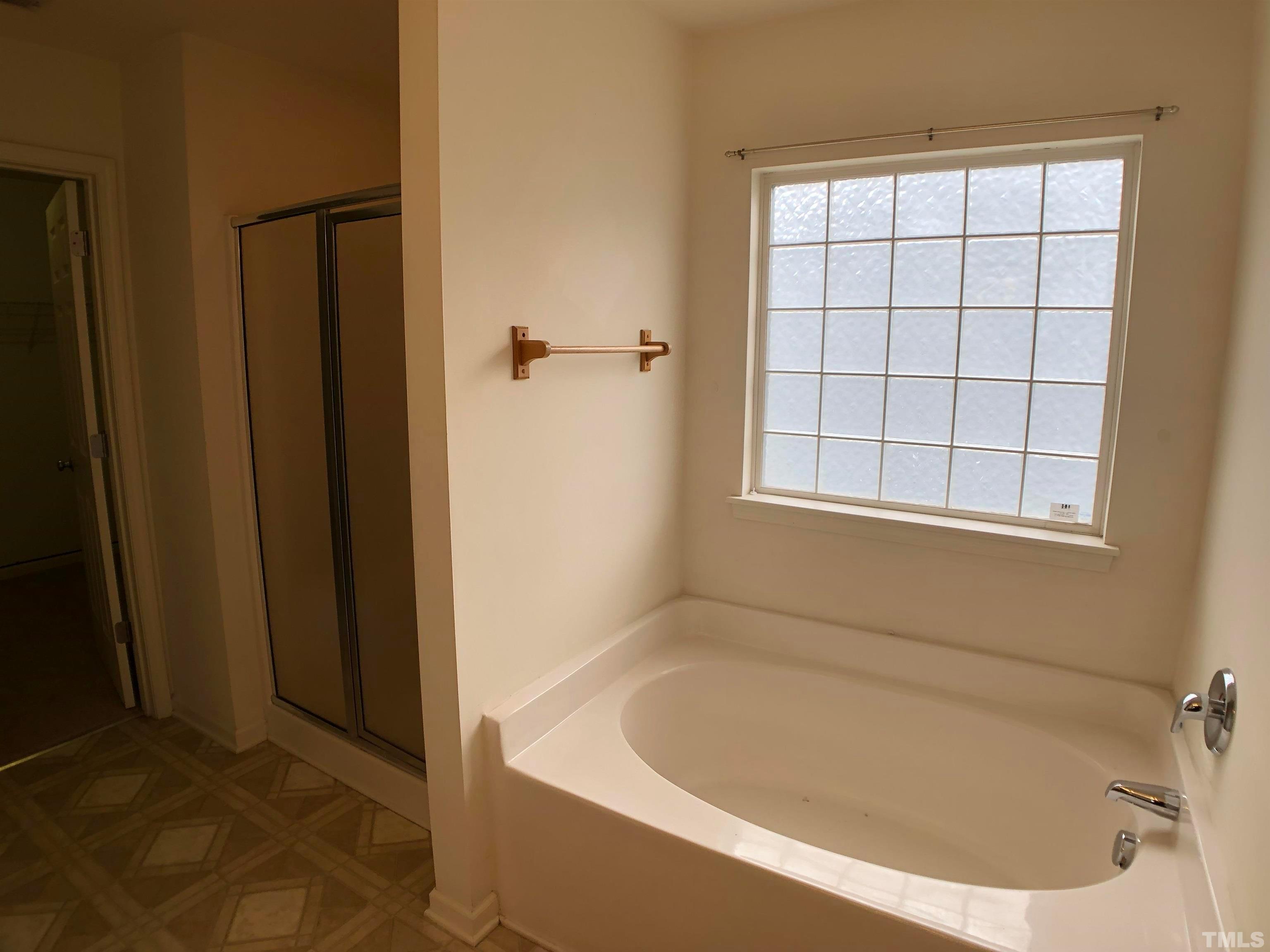 405 Hanson Road Durham, NC 27713 - Photo 17 of 27 a white bath tub sitting in a bathroom next to a window