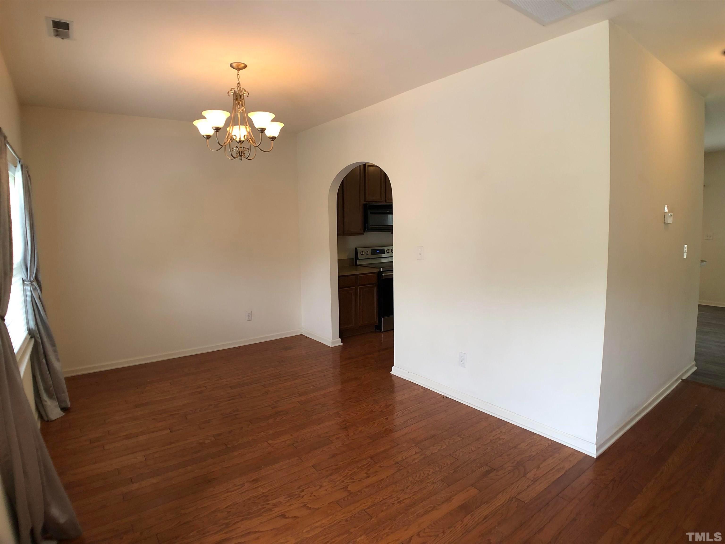 405 Hanson Road Durham, NC 27713 - Photo 3 of 27 wooden floor in an empty room with a window