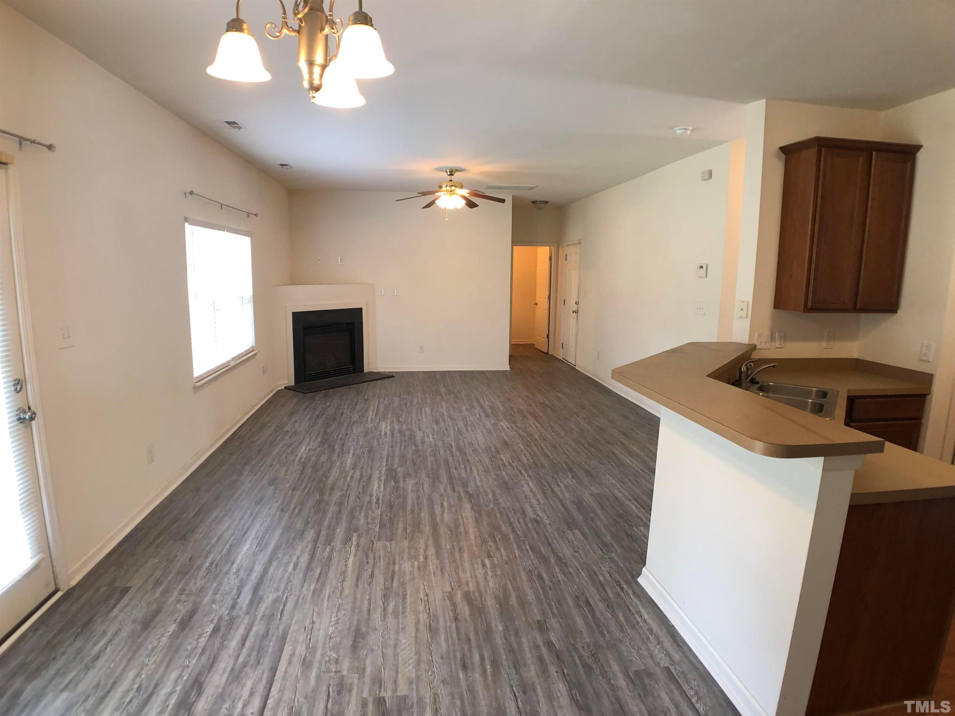 405 Hanson Road Durham, NC 27713 - Photo 10 of 27 a view of an empty room with wooden floor and a window