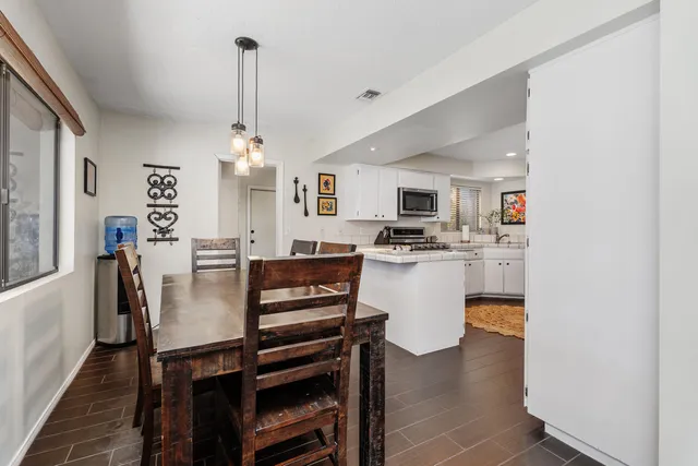 a dining room with furniture and window