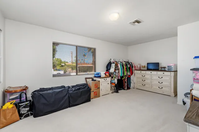 a bed room with furniture and a window