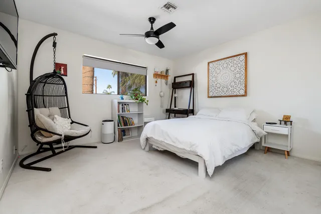 a bedroom with a bed a desk and chair