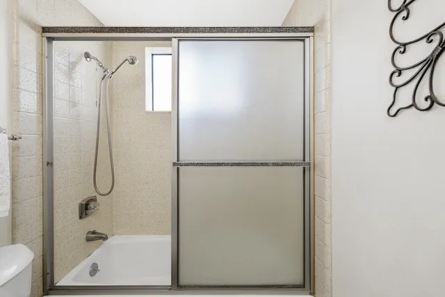 a bathroom with a glass shower door