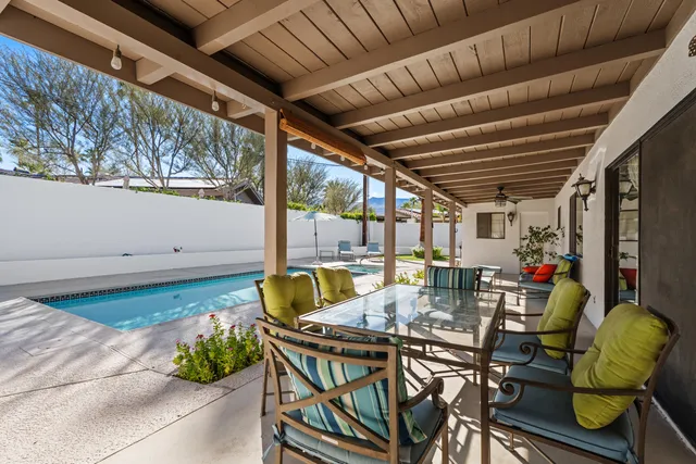 a view of a chairs and table in patio