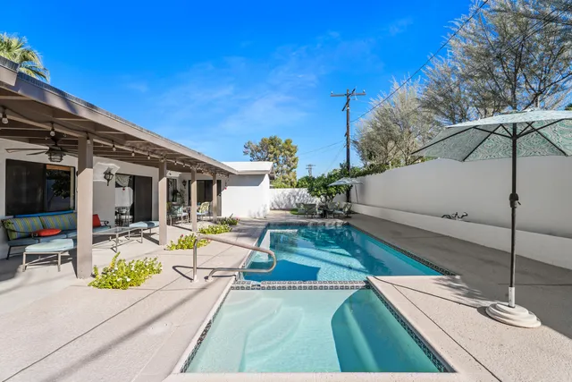 a view of a patio with swimming pool table and chairs