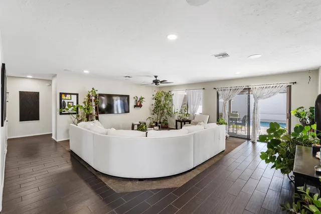 a view of living room with furniture and a potted plant