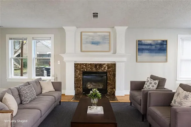 a living room with furniture and a fireplace