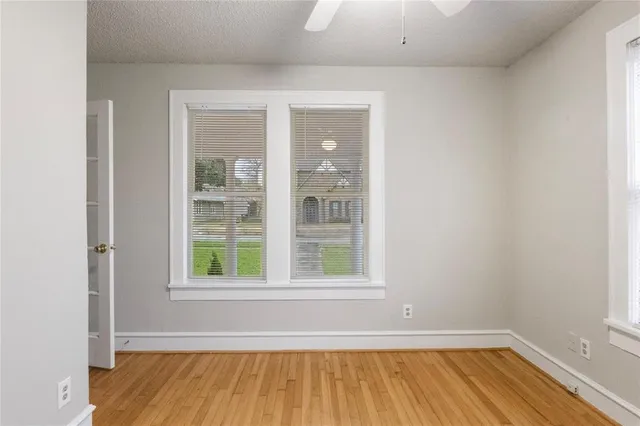 a view of a room with wooden floor and windows