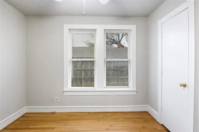 a view of a room with wooden floor and a window