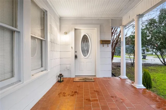 a view of a door of a house with a porch