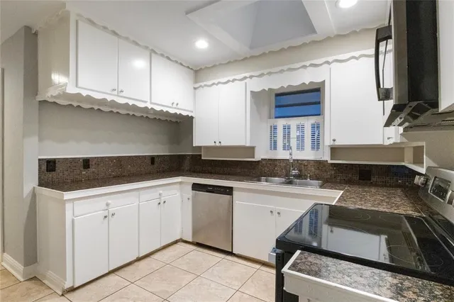 a kitchen with a sink stove and cabinets