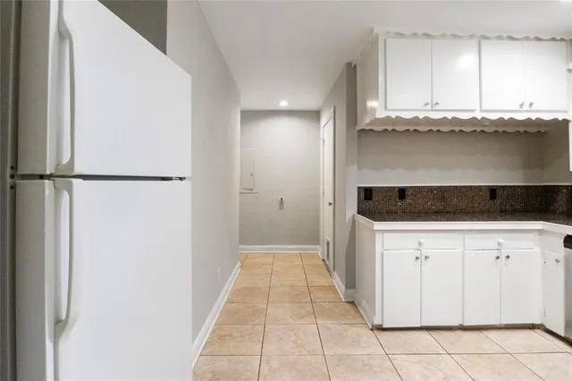 a view of a kitchen with granite countertop cabinets