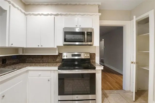 a kitchen with granite countertop a stove and a sink