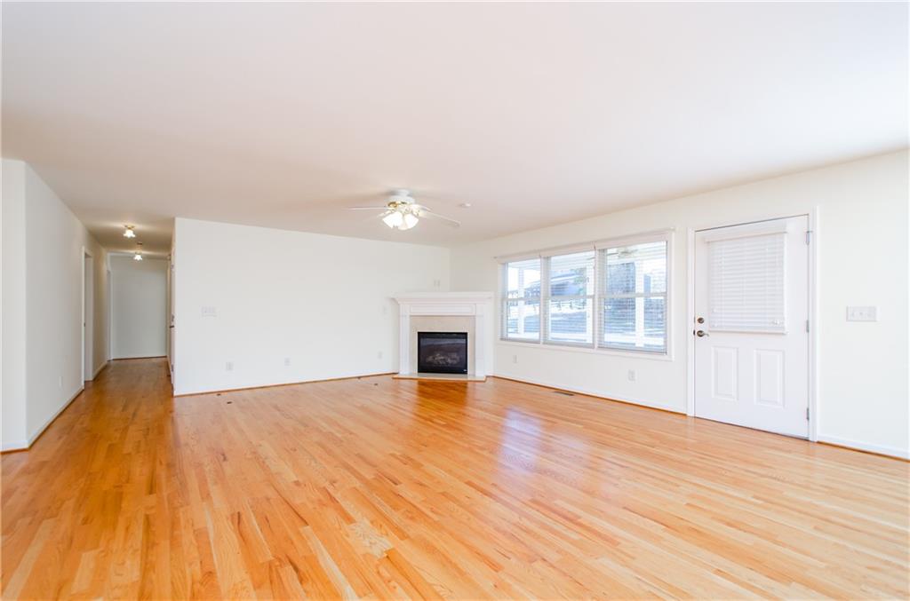 3950 Chattahoochee Road Cumming, GA 30041 - Photo 12 of 45 an empty room with wooden floor and fireplace