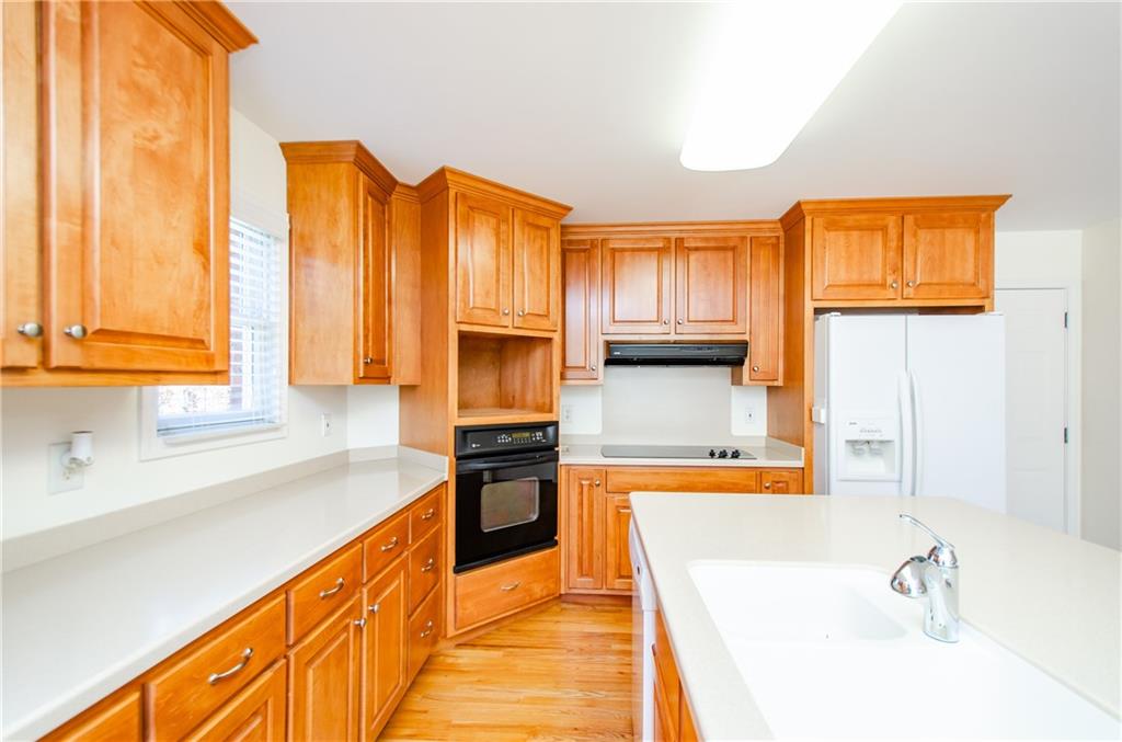 3950 Chattahoochee Road Cumming, GA 30041 - Photo 19 of 45 a kitchen with stainless steel appliances a sink a stove and a refrigerator