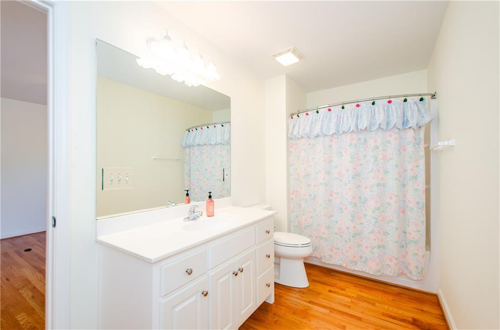 3950 Chattahoochee Road Cumming, GA 30041 - Photo 34 of 45 a bathroom with a sink a toilet and a large mirror