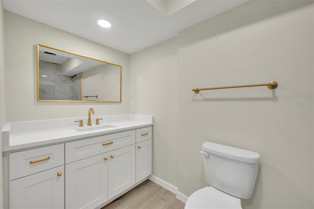 31201 Merry Road Tavares, FL 32778 - Photo 25 of 40 a bathroom with a toilet sink and mirror