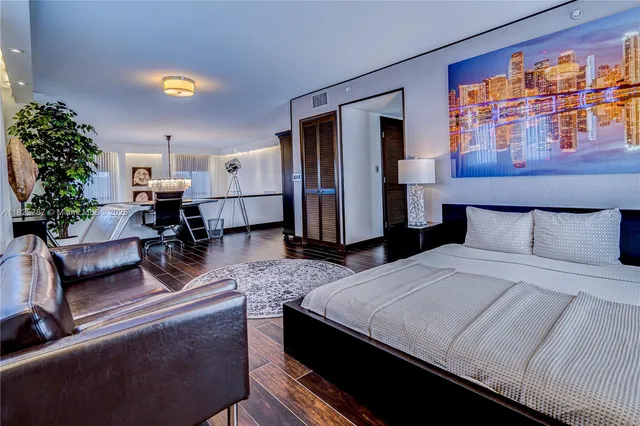 a bedroom with bed or couch and a potted plant