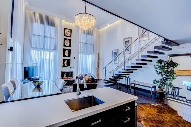 a view of kitchen and hall with wooden floor
