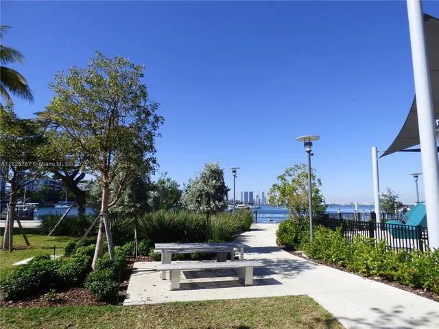 a couple of chairs sitting in patio with a backyard