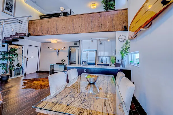 a living room filled with furniture and a wooden floor