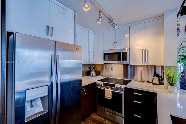 a kitchen with stainless steel appliances and wooden cabinets