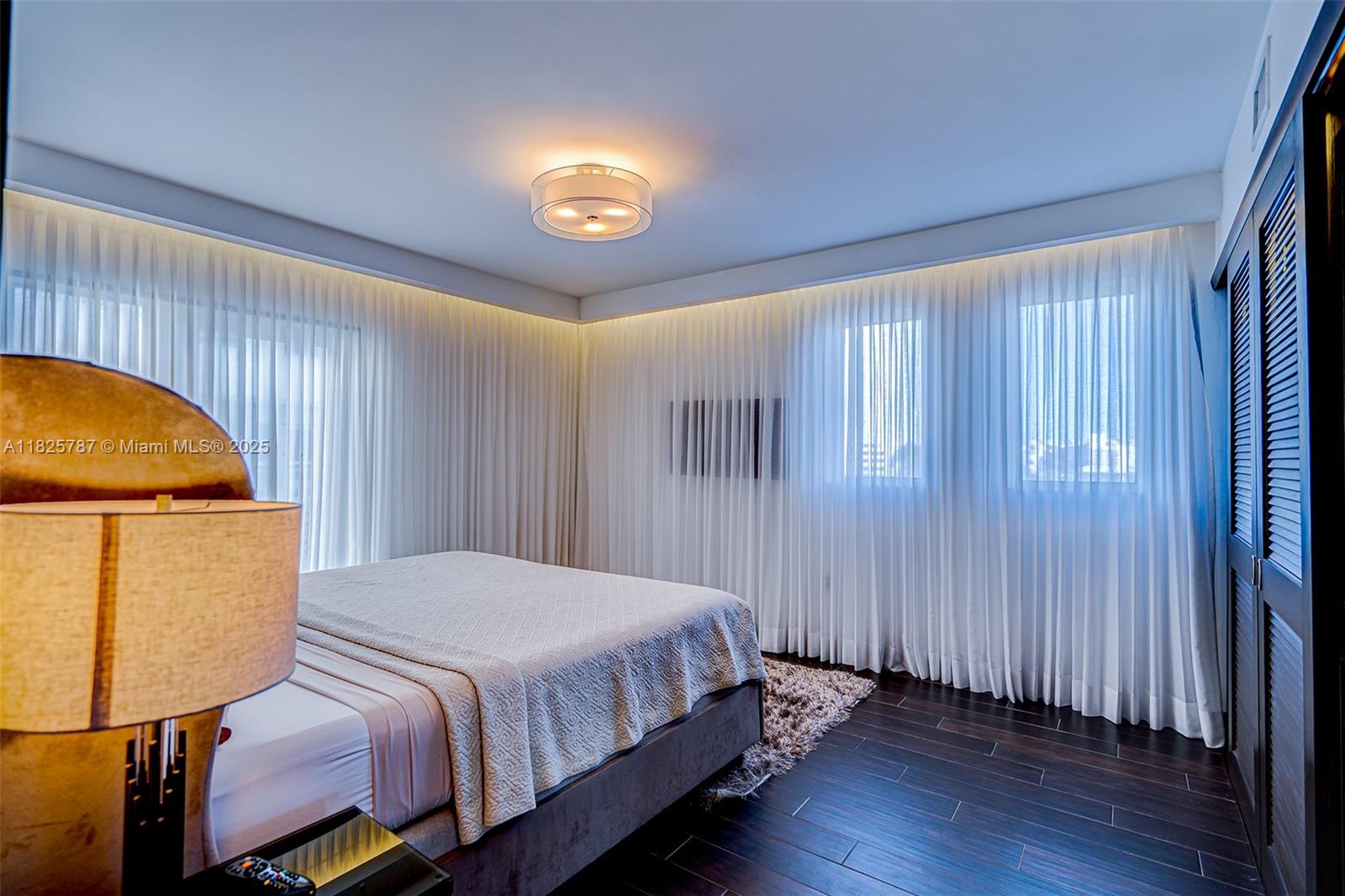 1701 Sunset Harbour Drive, Unit L507 Miami Beach, FL 33139 - Photo 9 of 28 a bedroom with a bed and a painting on the wall