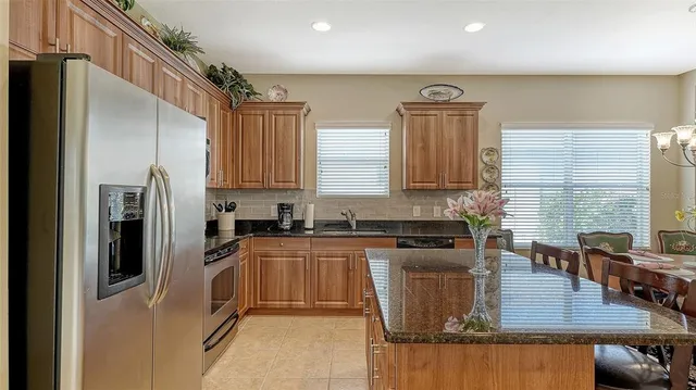 a dining room with furniture a chandelier and wooden floor