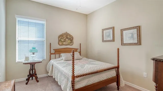 a bedroom with a bed next to a window