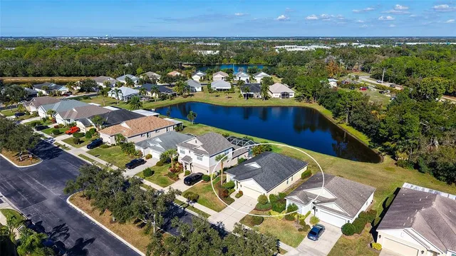 an aerial view of a house with a garden and lake view