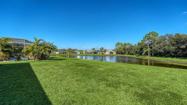 a view of a house with swimming pool and a yard