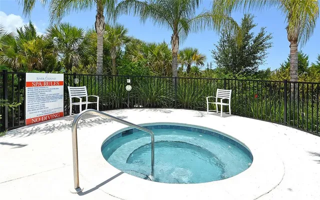 a view of house with a yard and sitting area