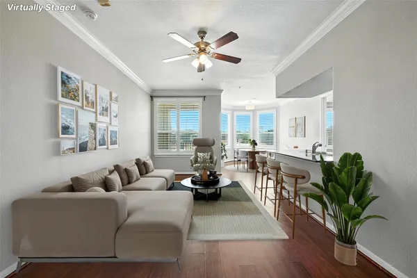 a living room with furniture potted plant and a chandelier