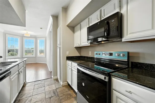 a kitchen with stainless steel appliances granite countertop a stove and a microwave