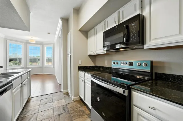 a kitchen with stainless steel appliances granite countertop a stove and a microwave