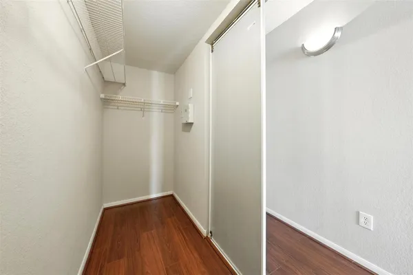a view of a room with wooden floor