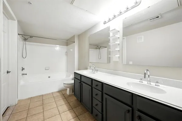 a bathroom with a double vanity sink mirror double and shower