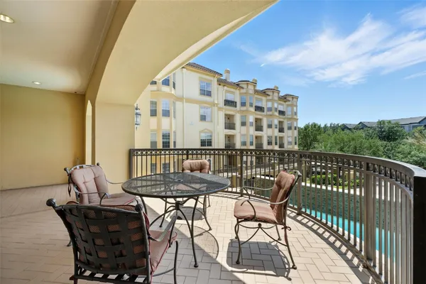 a view of balcony with a table and chairs