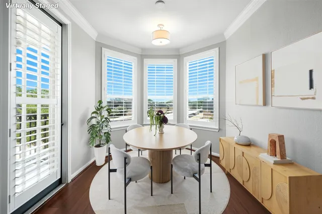 a dining room with furniture a chandelier and wooden floor