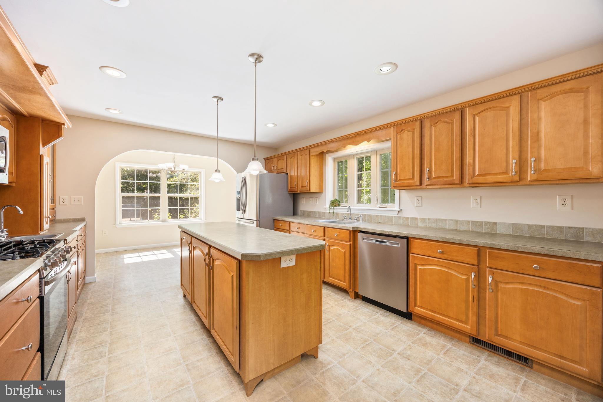 6635 Libertytown Road Berlin, MD 21811 - Photo 14 of 88 a kitchen with stainless steel appliances granite countertop wooden cabinets a sink and a stove