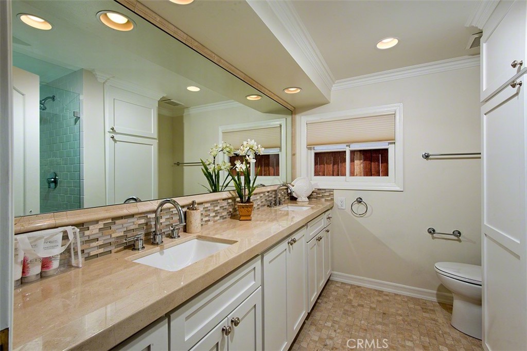 718 Emerald Bay Laguna Beach, CA 92651 - Photo 14 of 20 a bathroom with a granite countertop sink mirror and toilet