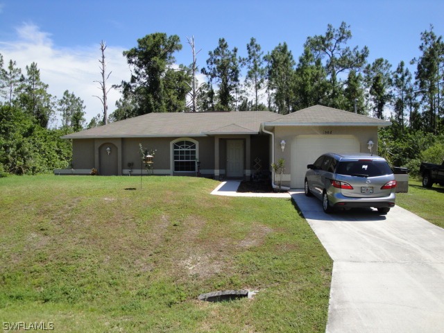 4502 East 21st Street Alva, FL 33920 - Photo 1 of 2 a house view with a garden space