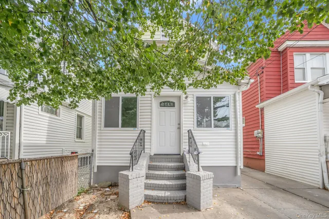a view of a house with a tree front of house