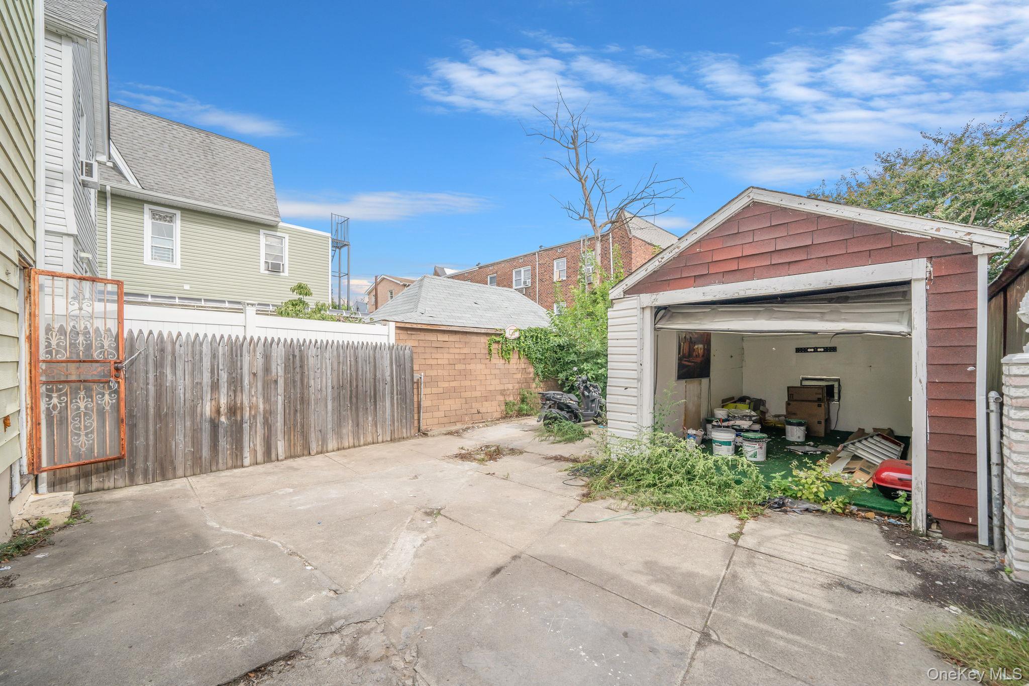 101-31 116th Street Queens, NY 11419 - Photo 5 of 19 a front view of a house with garden