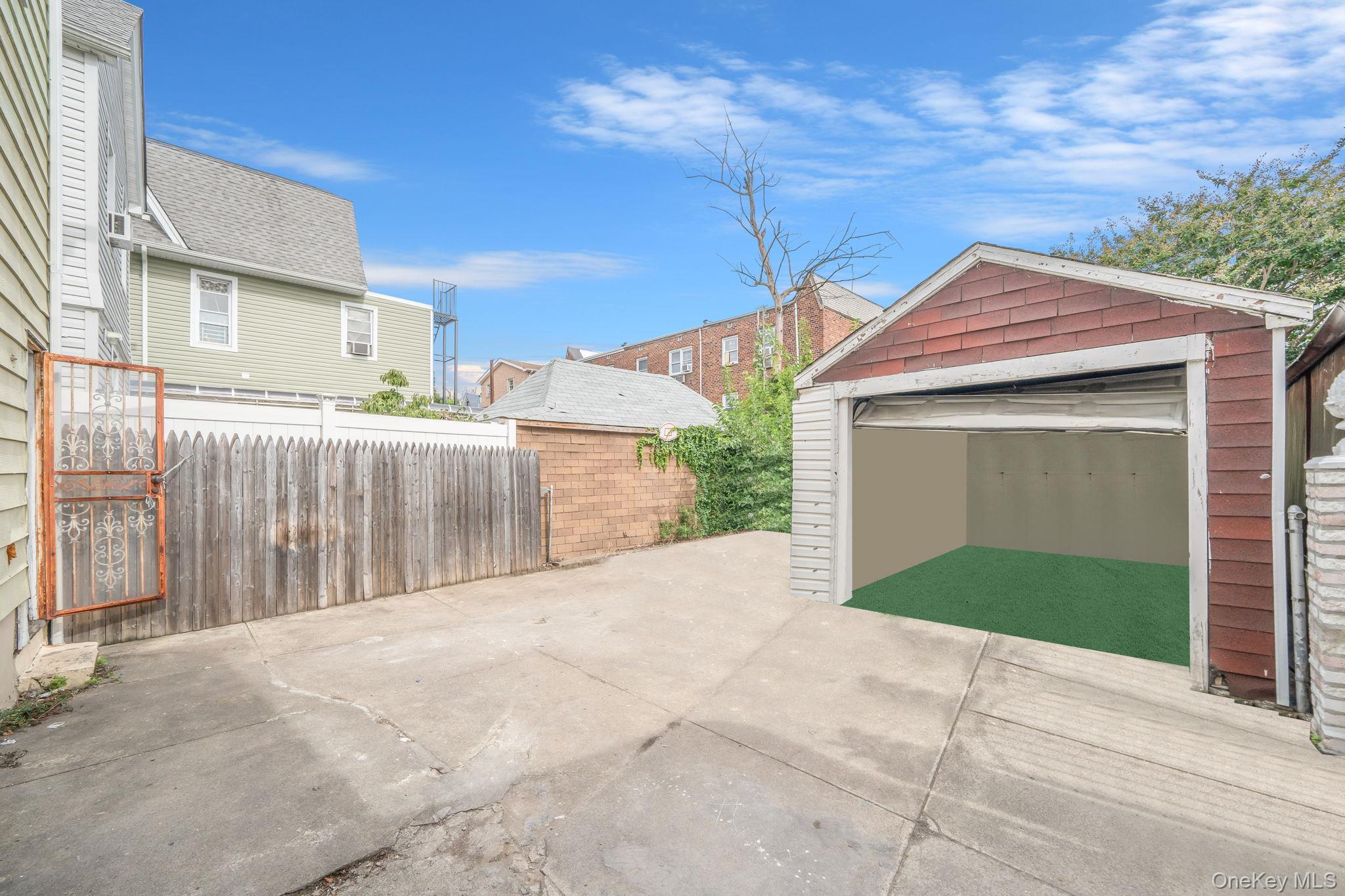 101-31 116th Street Queens, NY 11419 - Photo 6 of 19 a front view of a house with garage