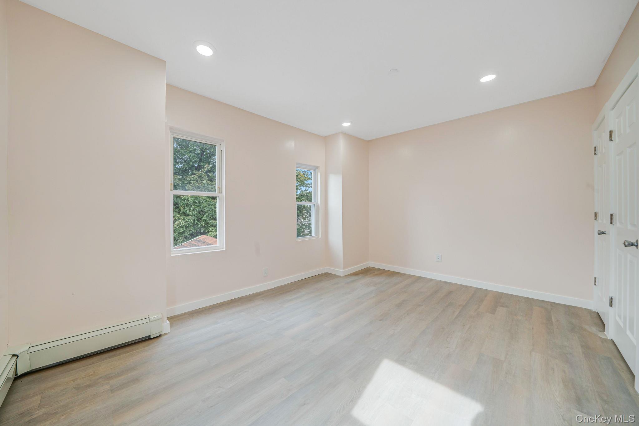 101-31 116th Street Queens, NY 11419 - Photo 8 of 19 an empty room with windows