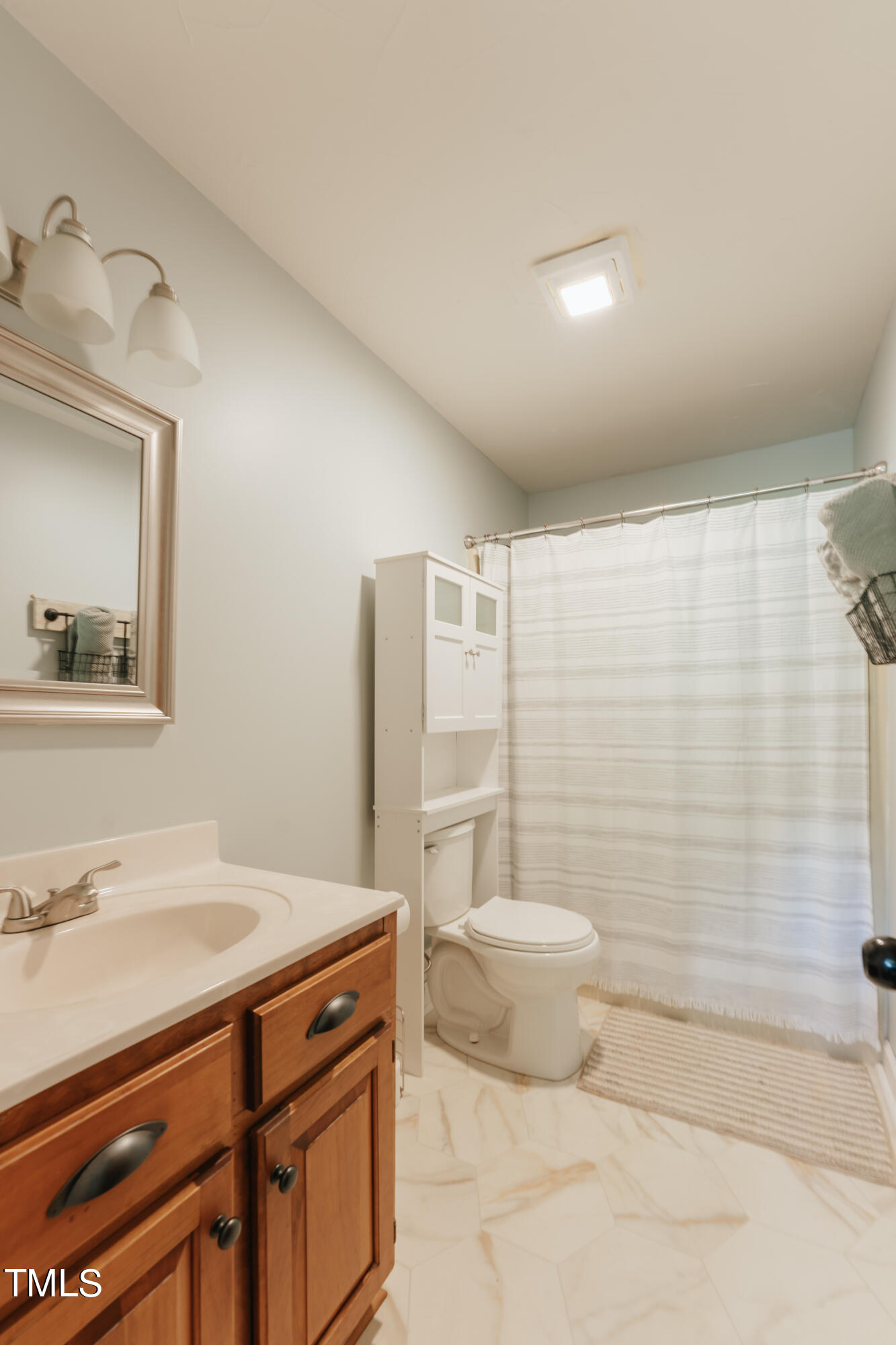 55 Sycamore Road Roxboro, NC 27574 - Photo 19 of 73 a bathroom with a sink toilet and shower