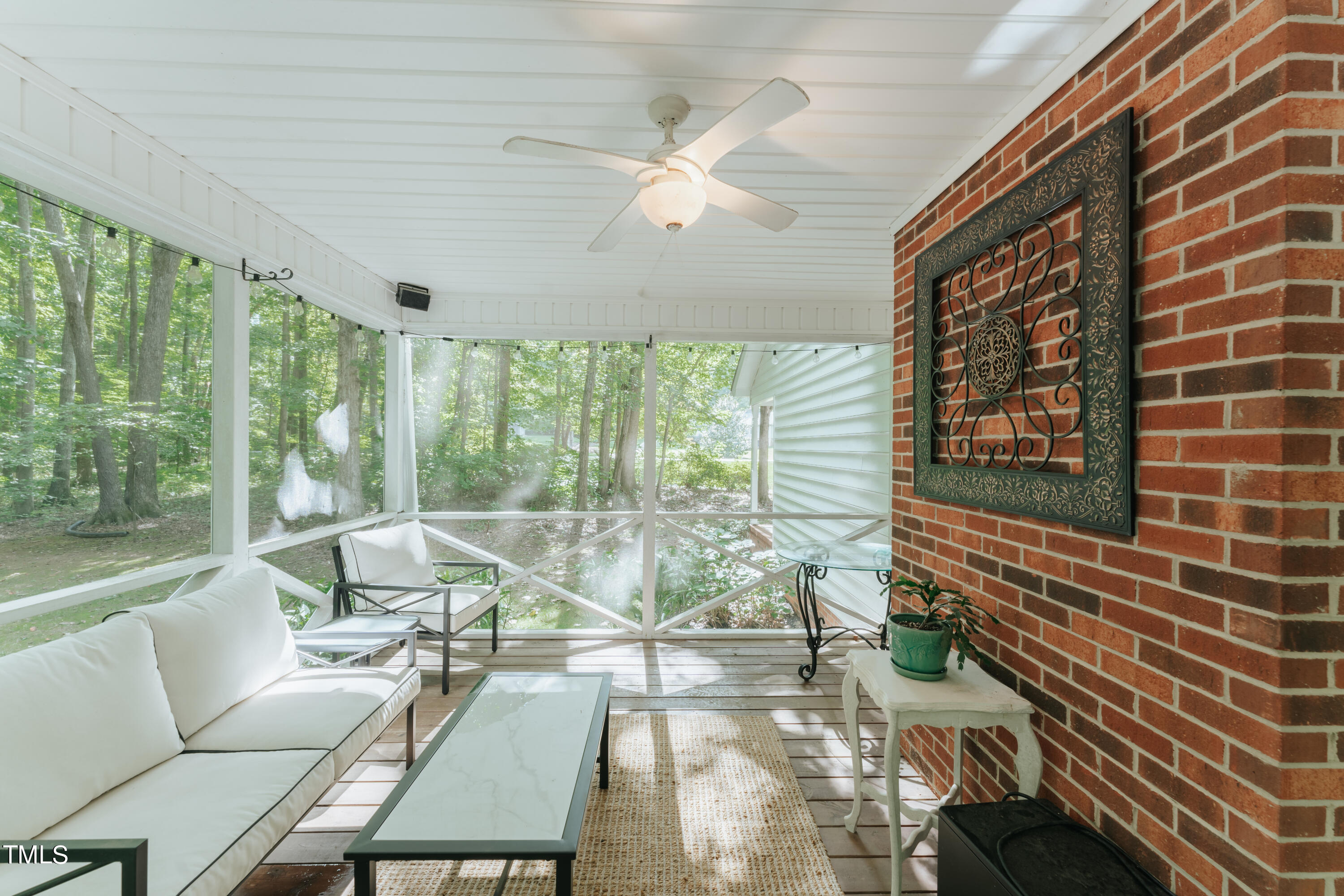 55 Sycamore Road Roxboro, NC 27574 - Photo 39 of 73 a living room with furniture and a floor to ceiling window