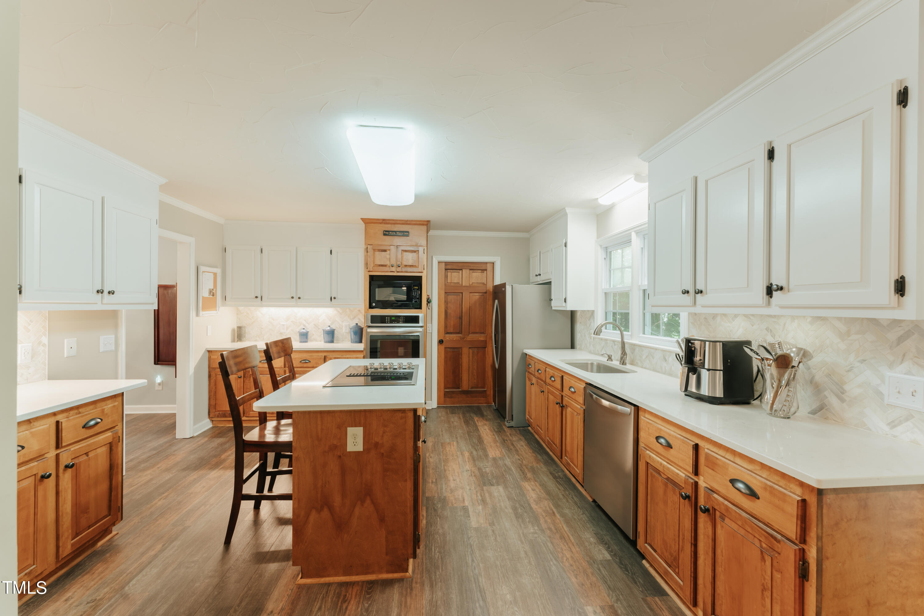 55 Sycamore Road Roxboro, NC 27574 - Photo 49 of 73 a kitchen with stainless steel appliances granite countertop a kitchen island hardwood floor sink stove dining table and chairs