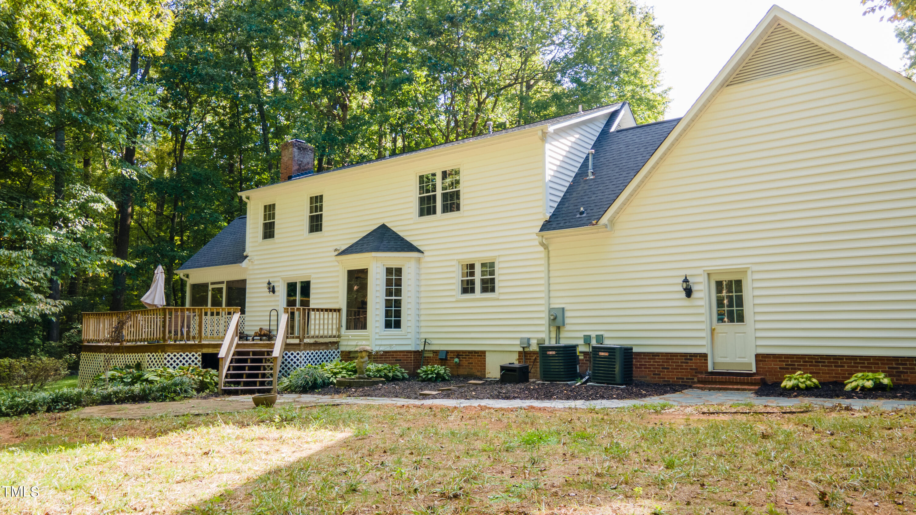 55 Sycamore Road Roxboro, NC 27574 - Photo 67 of 73 a view of a white house with large windows and a yard